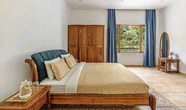 Premium luxury bedroom at Punya Farms offering comfort and privacy near Isha Yoga Center.